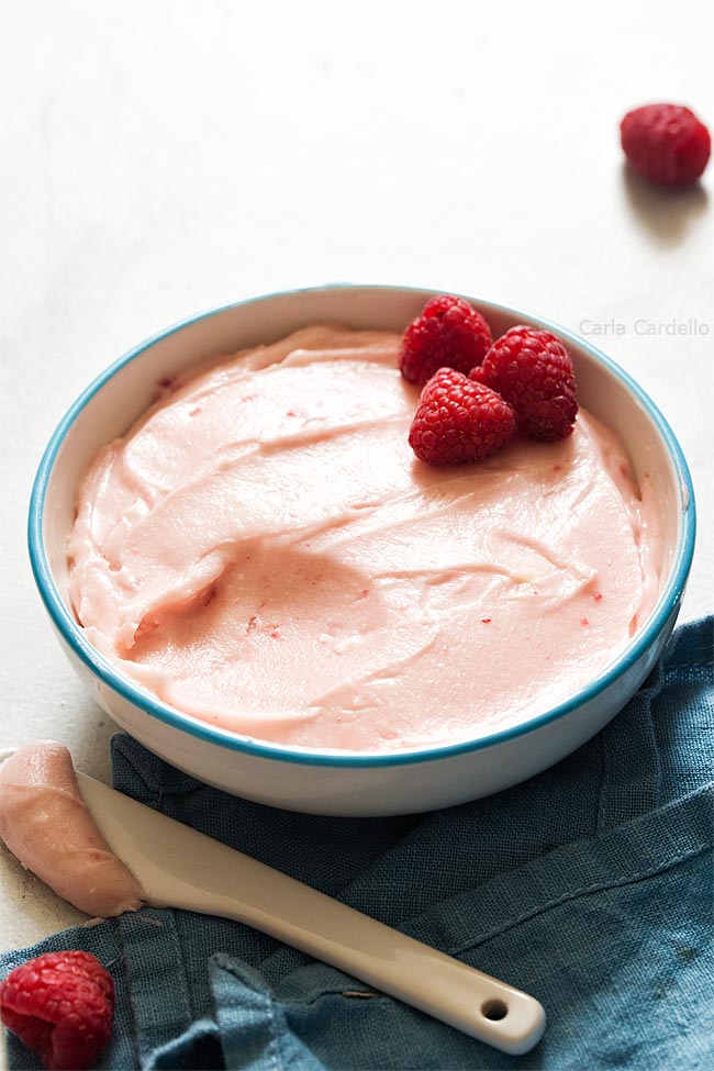 Raspberry cream cheese frosting in white bowl