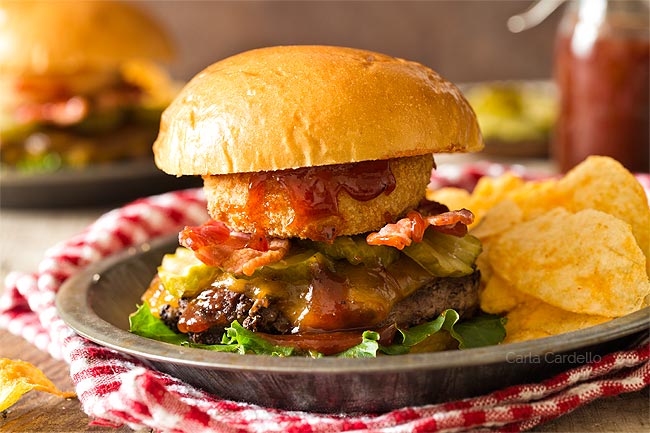 BBQ burgers in a plate with chips and red checked napkin