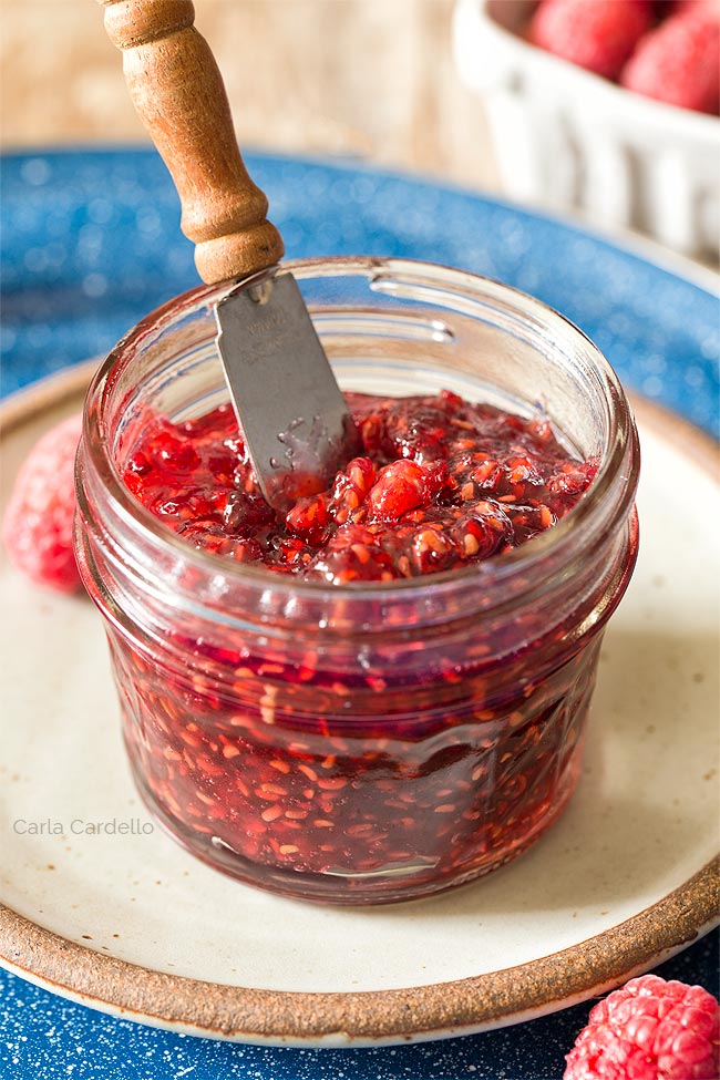 Raspberry Jam in mini jar with knife sticking out