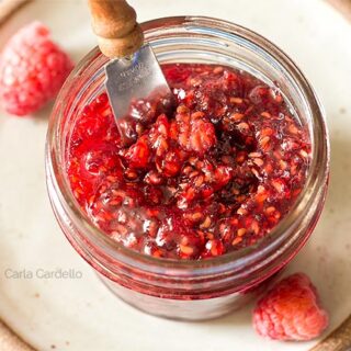 Raspberry Jam in mini jar with knife sticking out