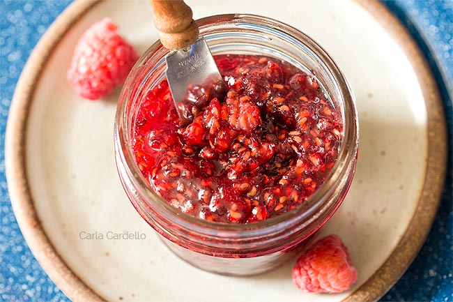 Raspberry Jam in mini jar with knife sticking out