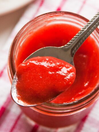 Close up of spoon with strawberry curd