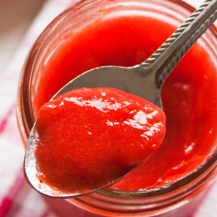 Close up of spoon with strawberry curd