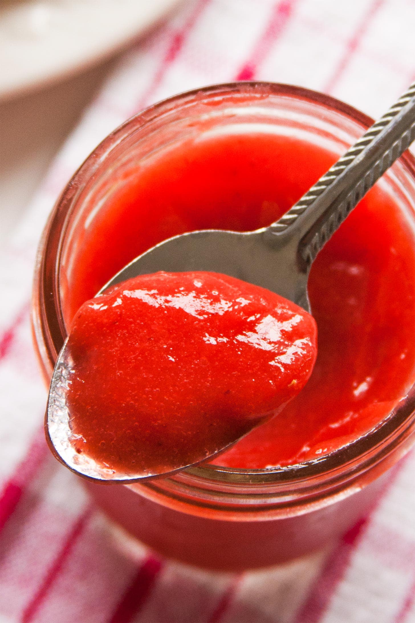 Close up of spoon with strawberry curd