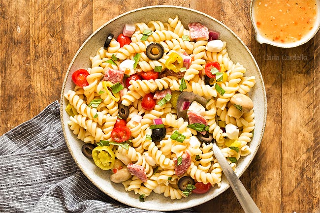 Bowl of antipasto pasta salad with spoon