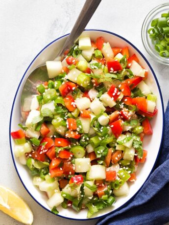 White bowl filled with green onion salad