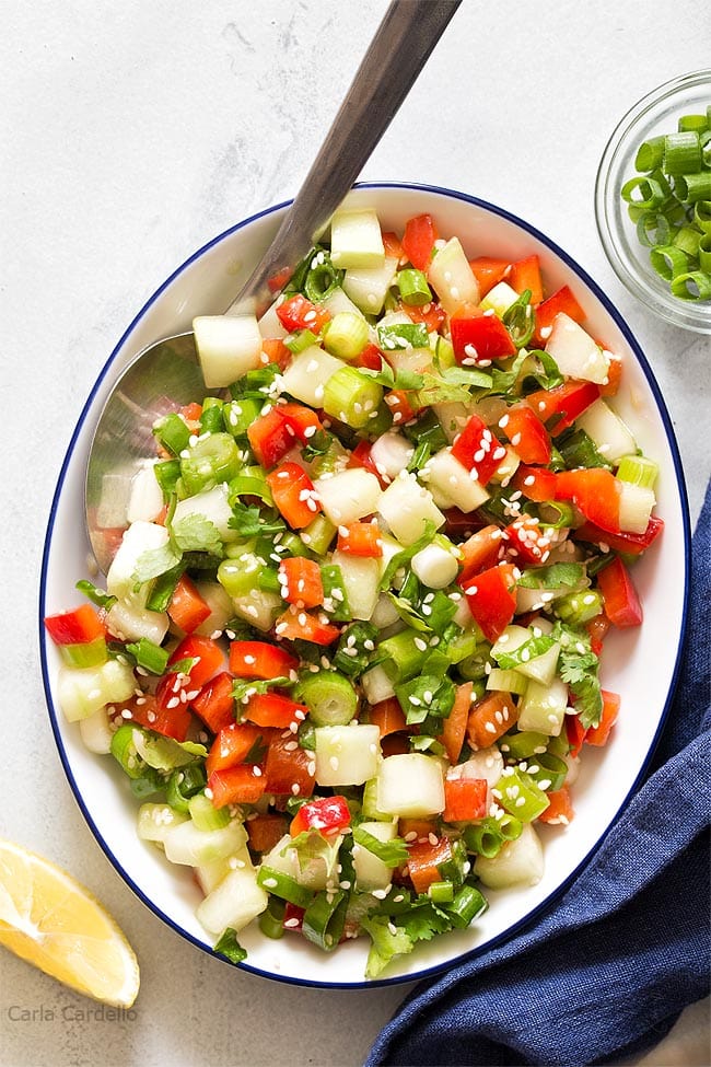 White bowl filled with green onion salad