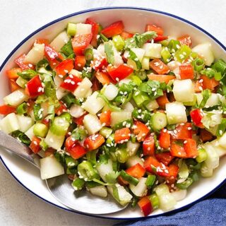 White bowl filled with green onion salad