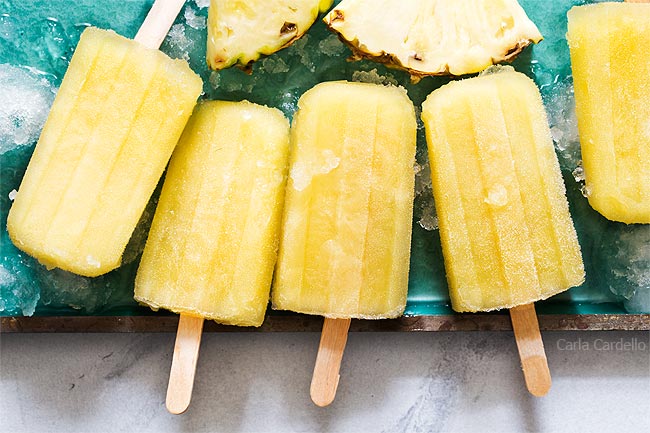 Pineapple popsicles on a teal tray