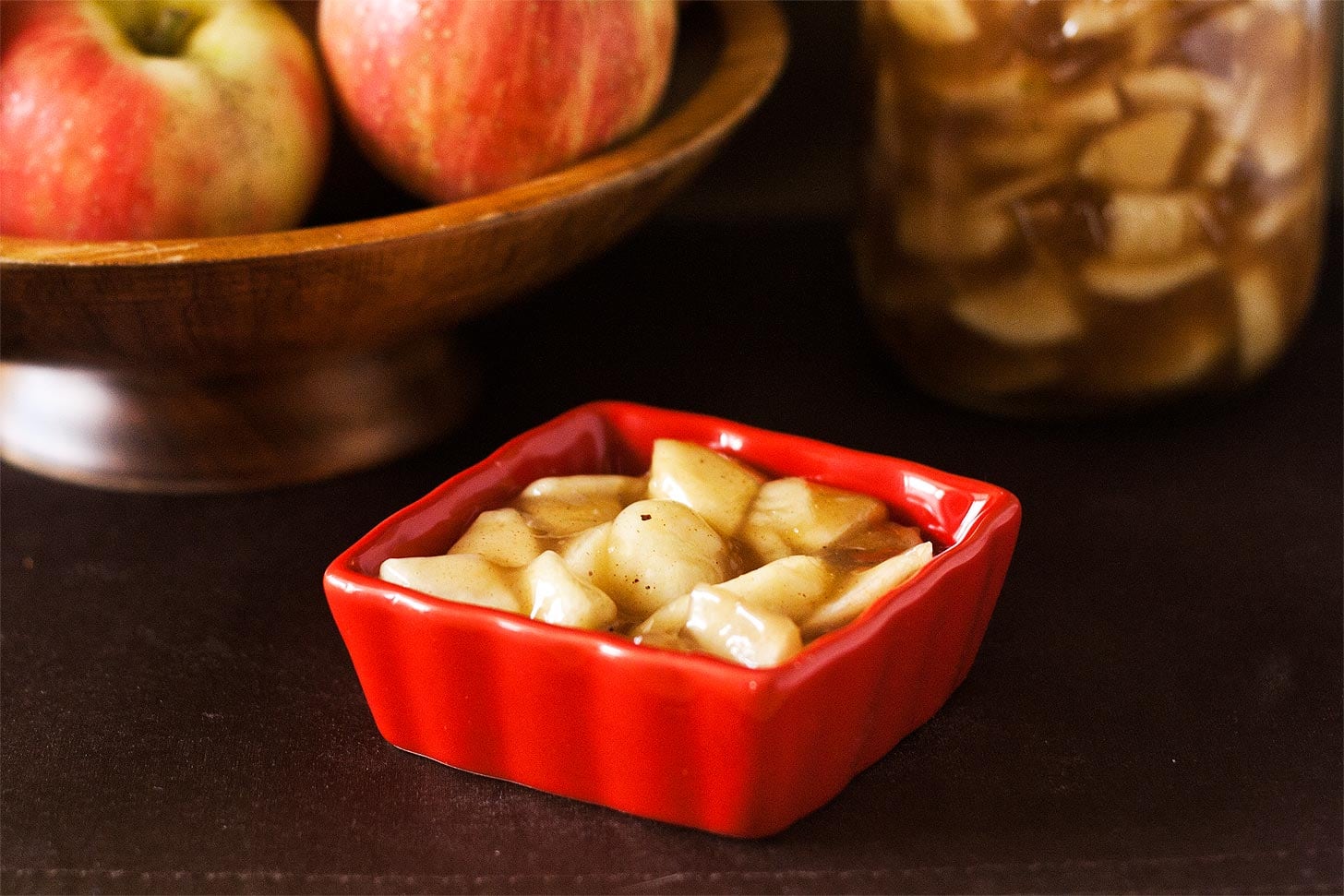 Homemade apple pie filling recipe in a red bowl