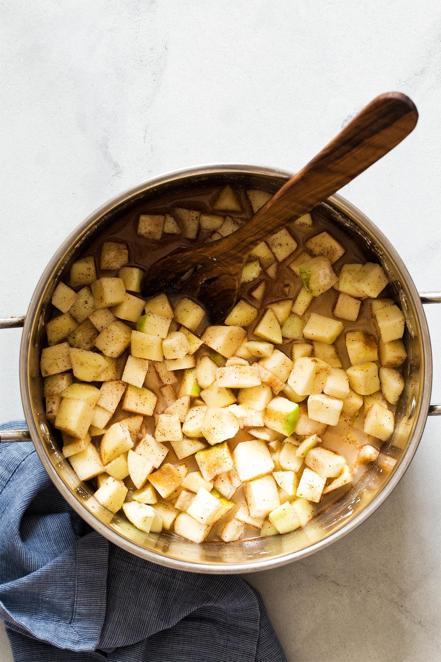 Apples tossed with sugar and spices in a large pot