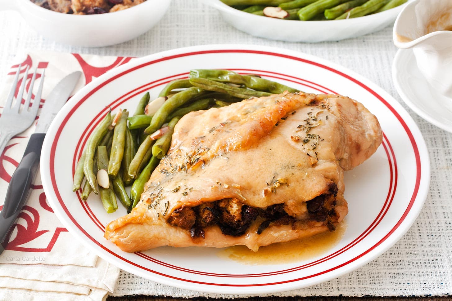 Stuffed turkey breast on plate with green beans