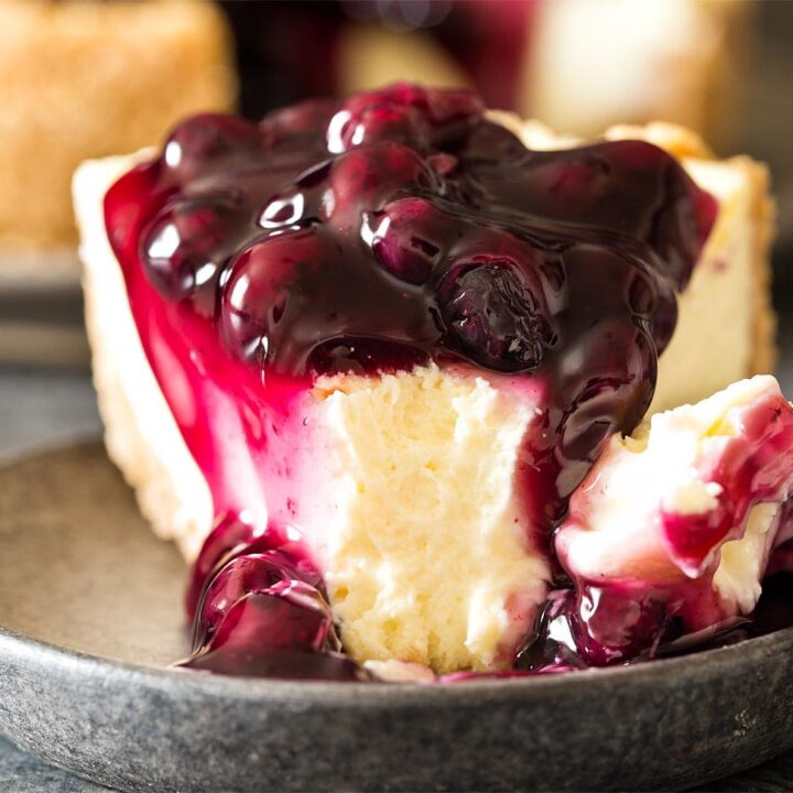 Slice of 7 inch cheesecake with blueberry pie filling