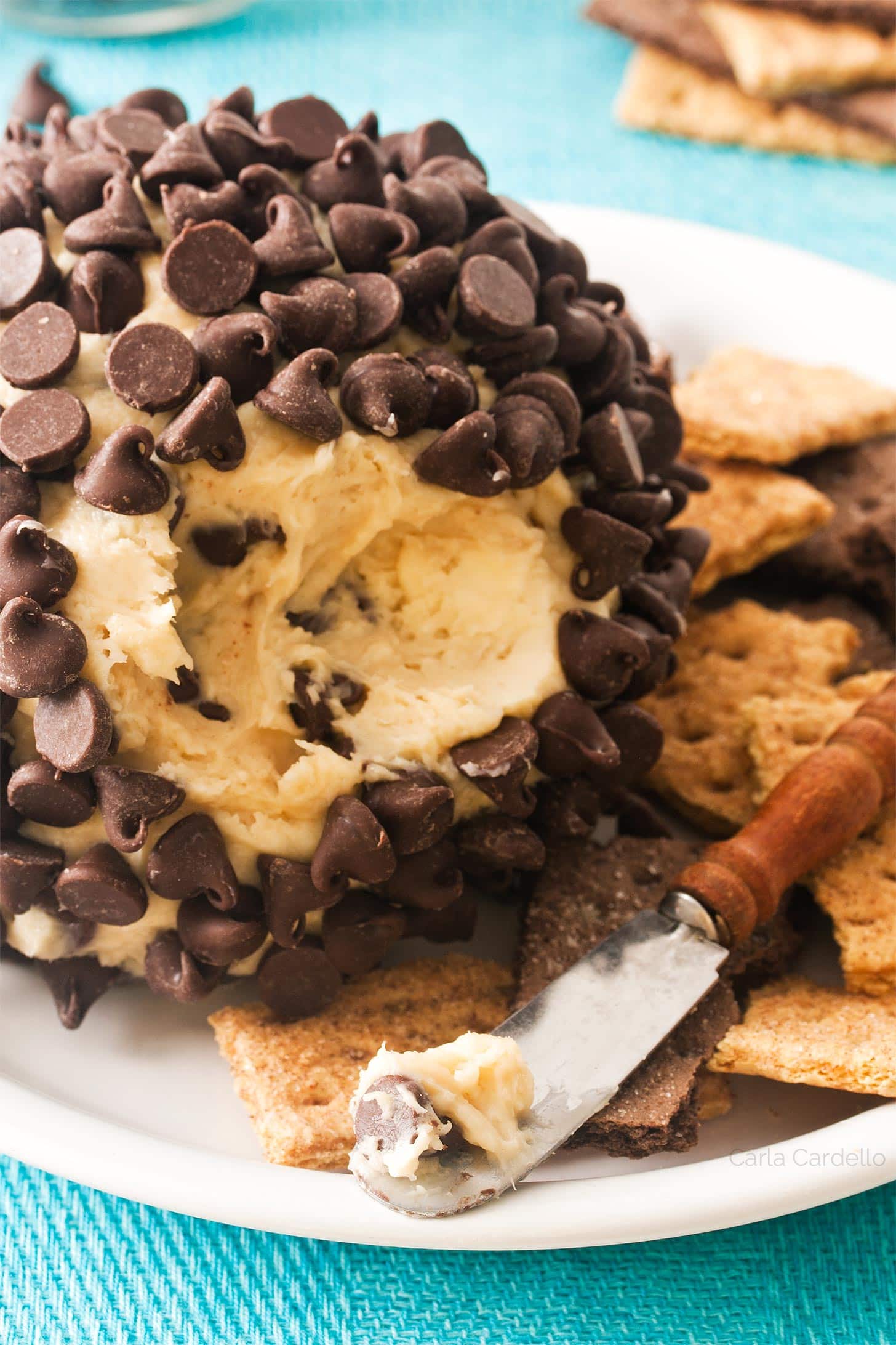 Close up of chocolate chip cheeseball on knife