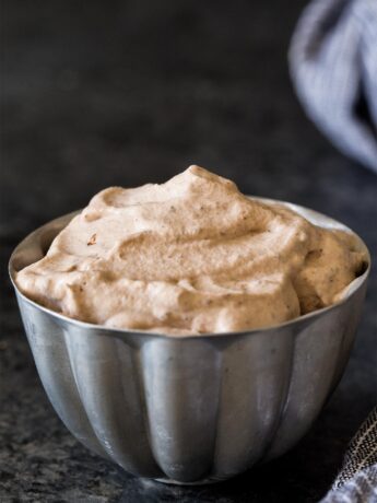 Chocolate whipped cream in small silver bowl