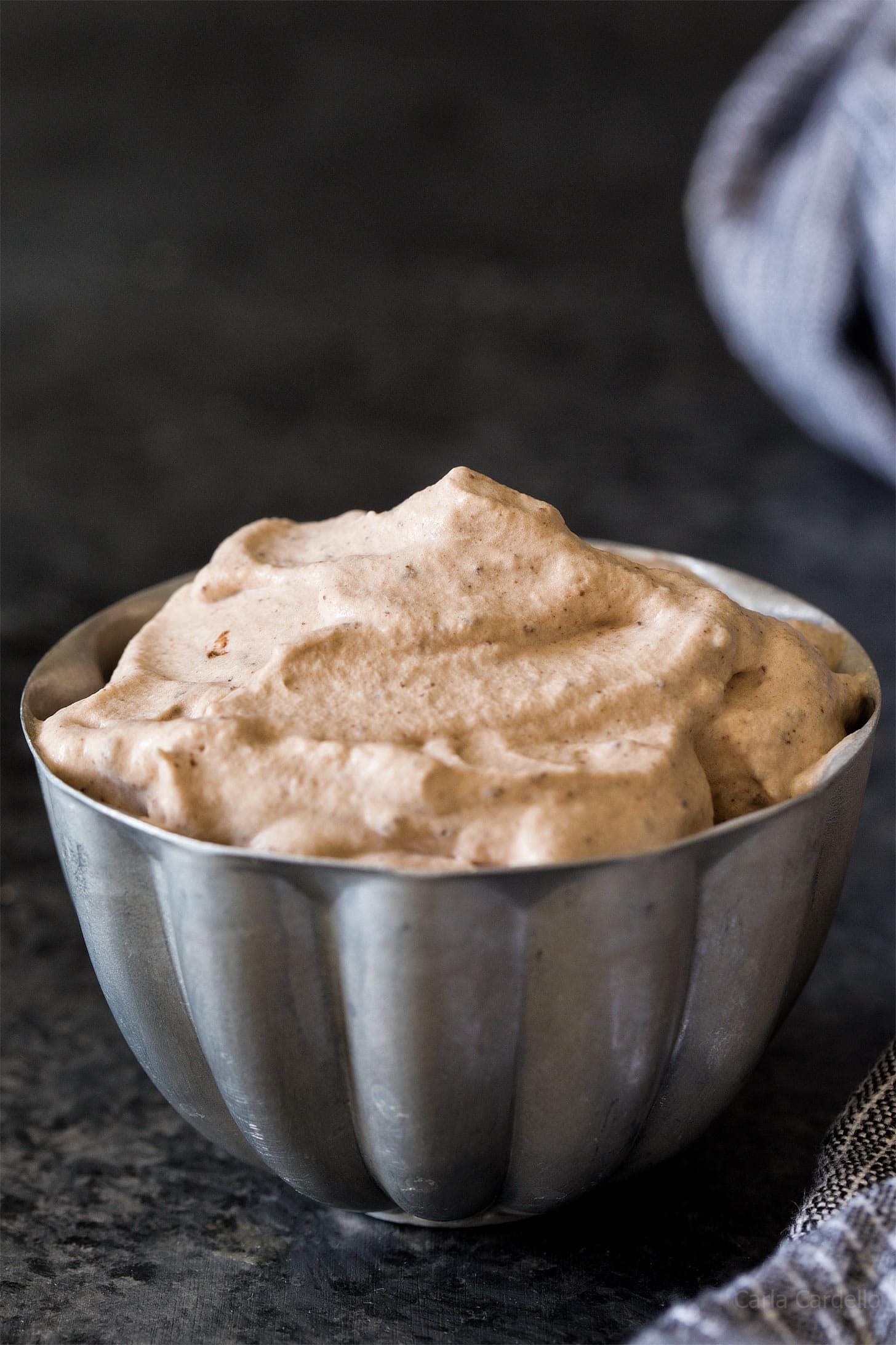 Chocolate whipped cream in small silver bowl