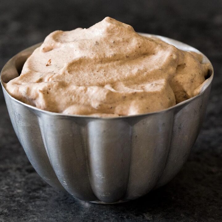 Cocoa whipped cream in silver bowl