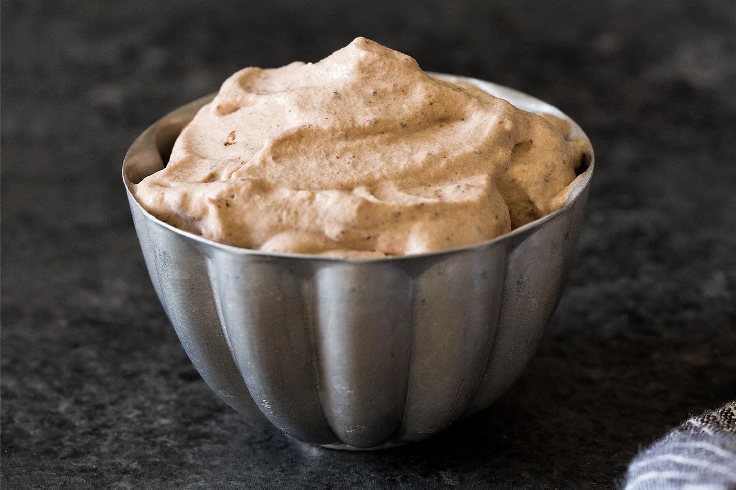 Cocoa whipped cream in silver bowl