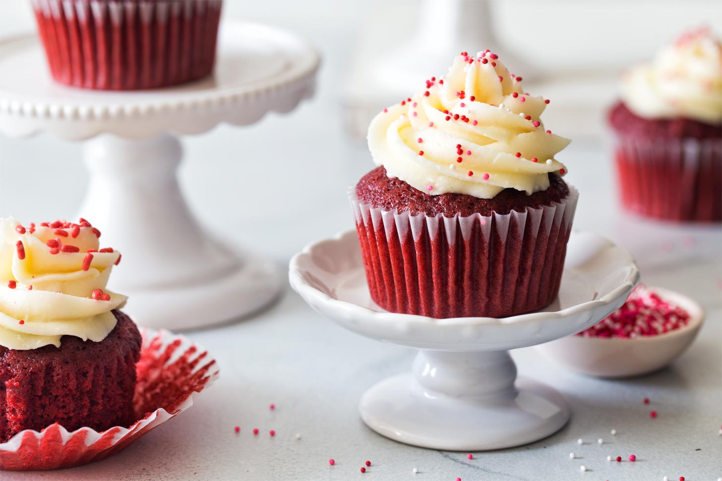 Red velvet cupcakes on mini cake stands