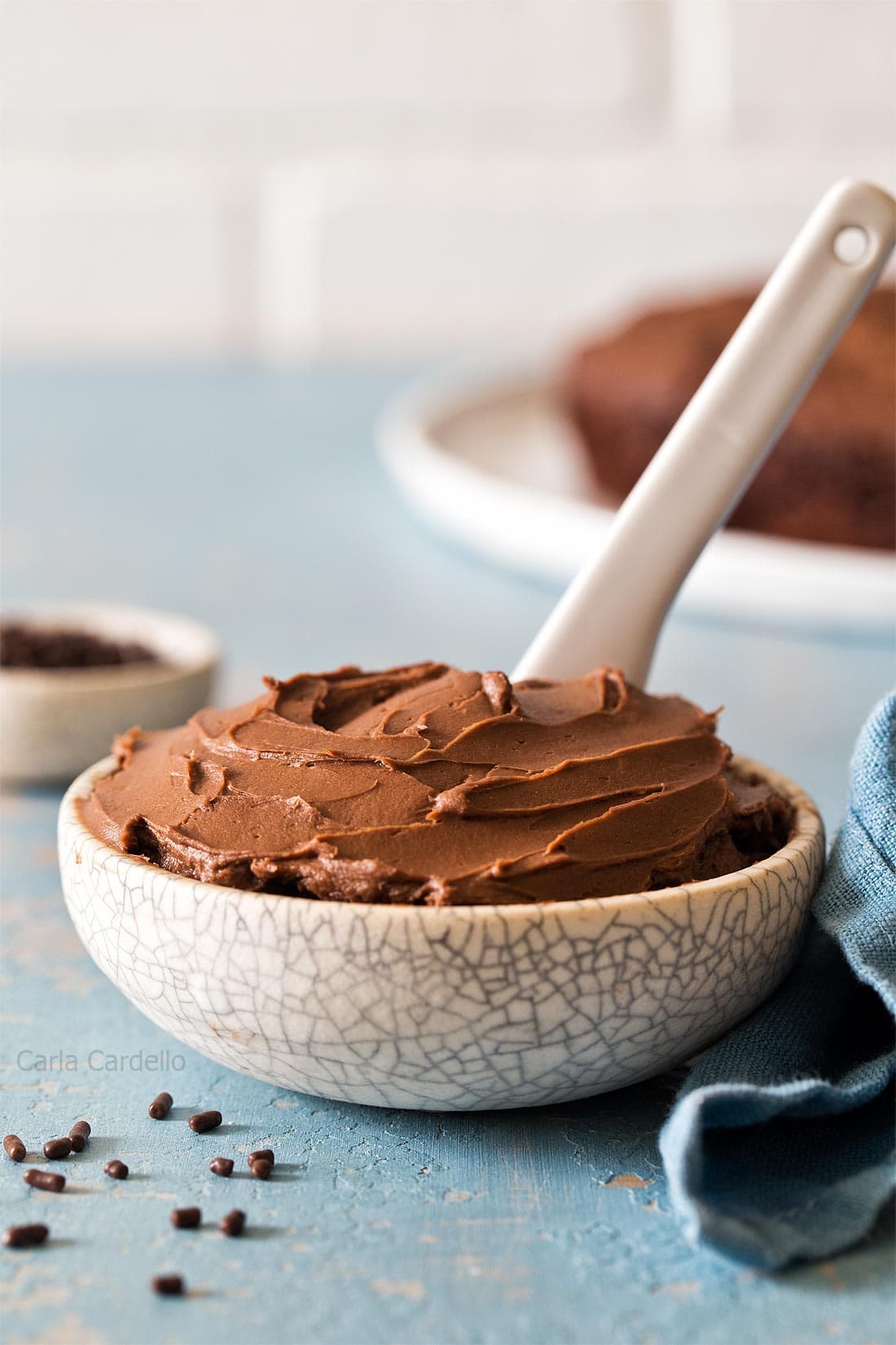 Chocolate Cream Cheese Frosting with white knife in small bowl