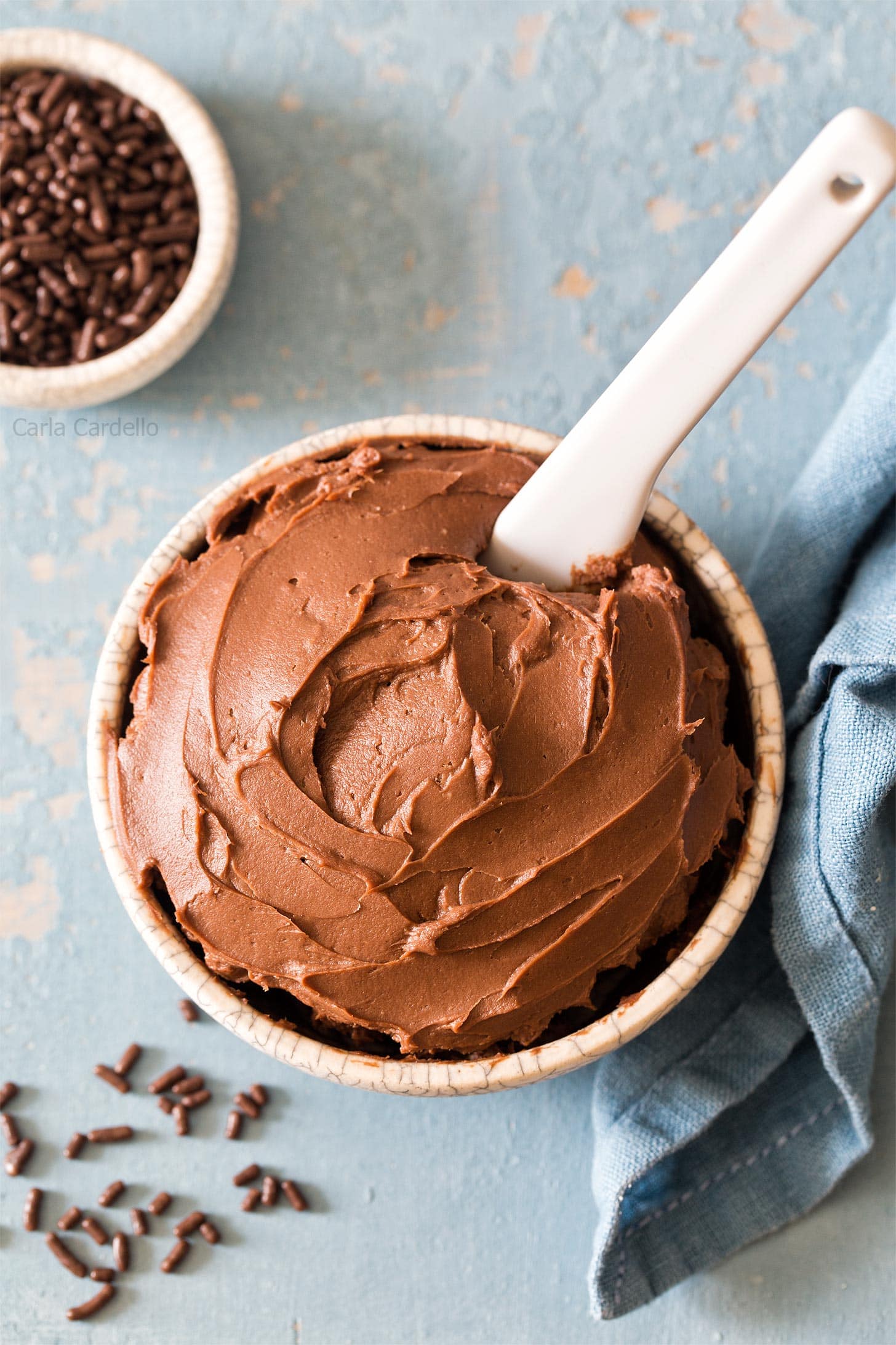 Cream Cheese Chocolate Frosting in small bowl with white knife