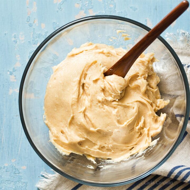 Glass bowl with cream cheese peanut butter frosting