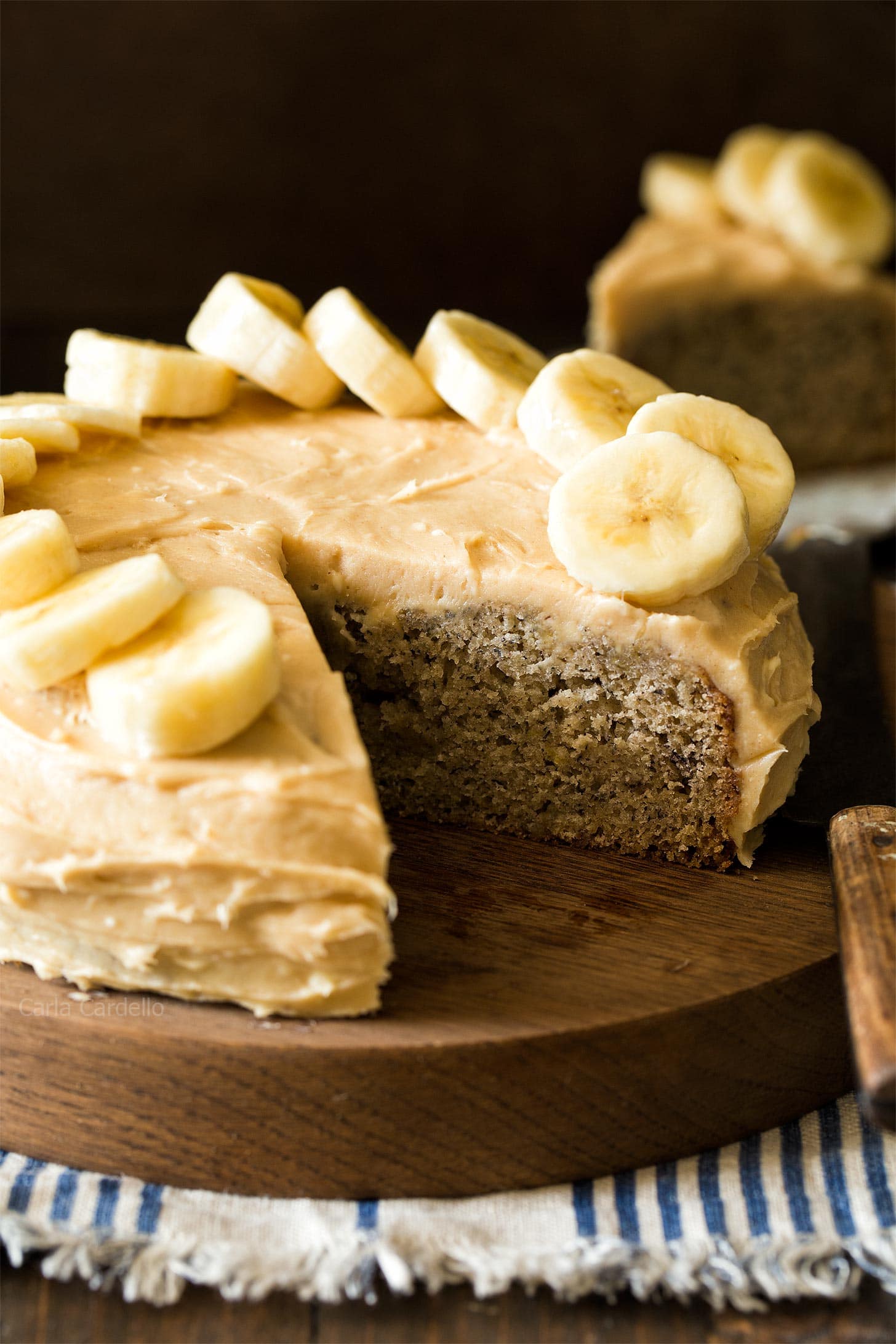 Small Banana Cake on wooden board with slice cut out