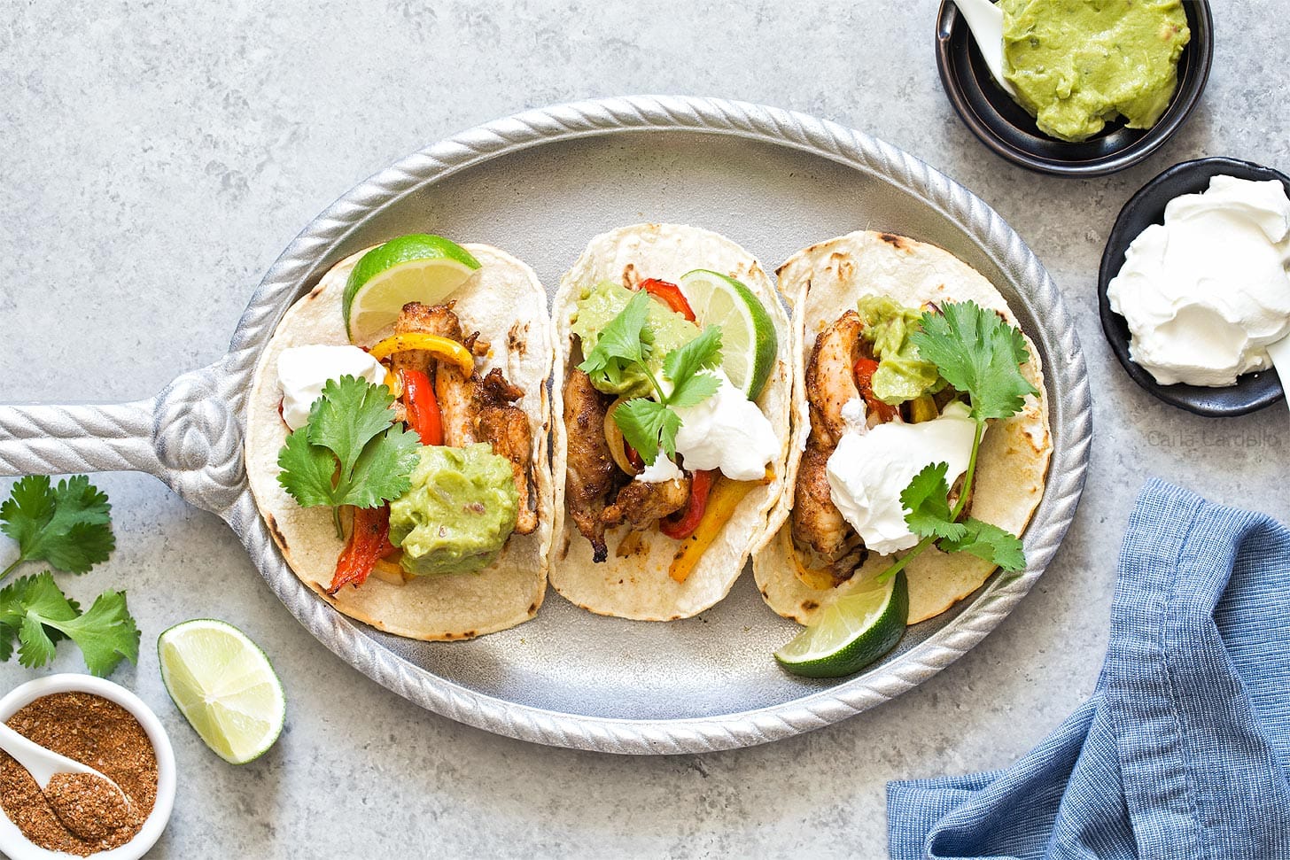 Chicken Fajitas in corn tortillas on silver plate