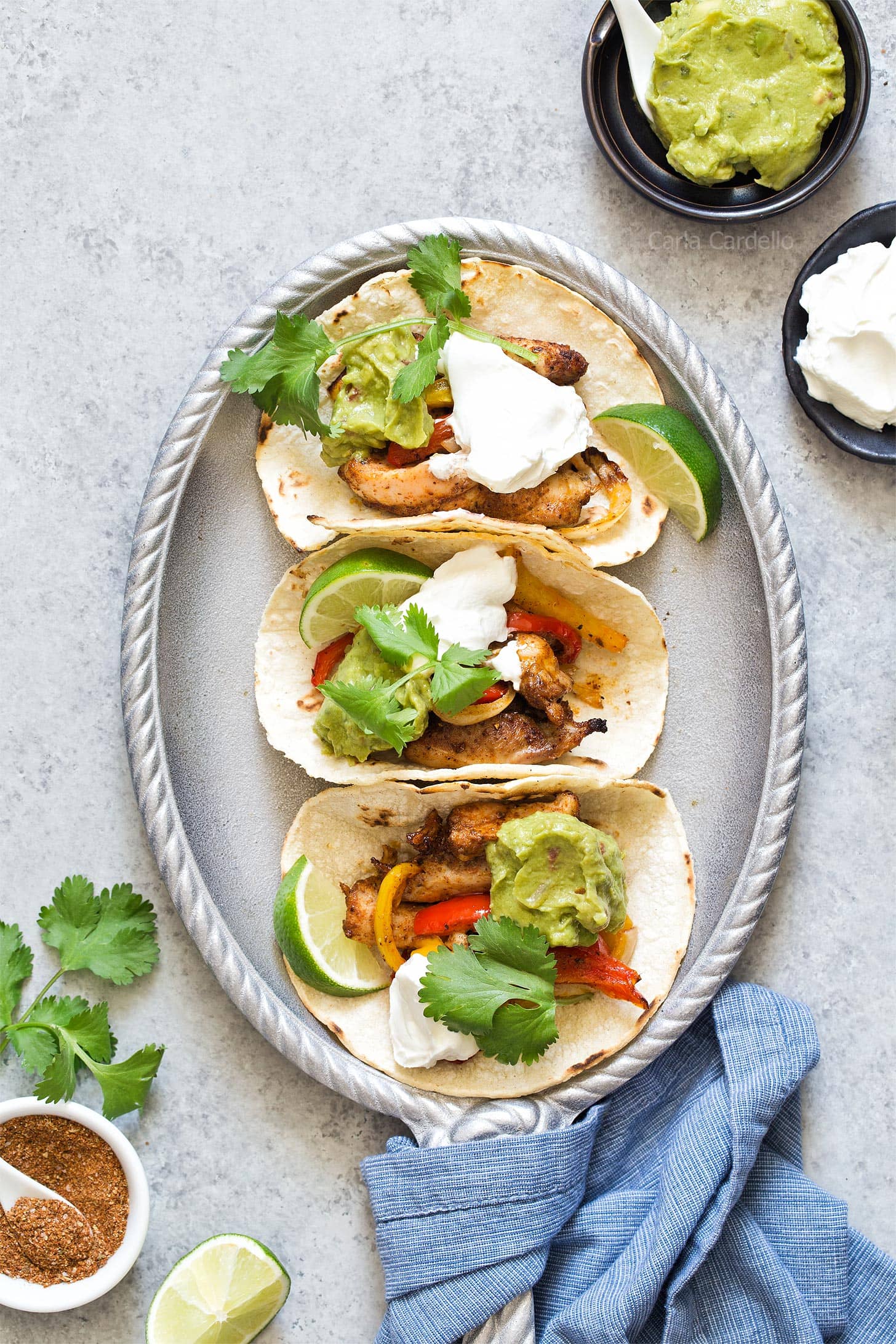 Chicken Fajitas in corn tortillas on silver plate