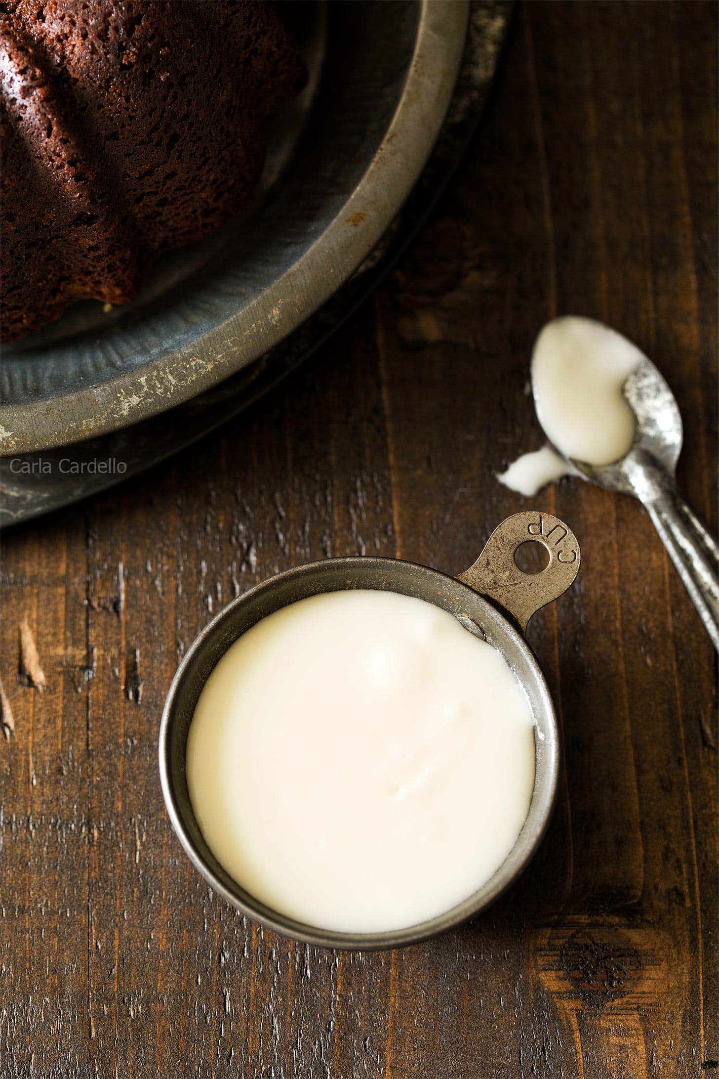 Bundt cake glaze in a cup with spoon