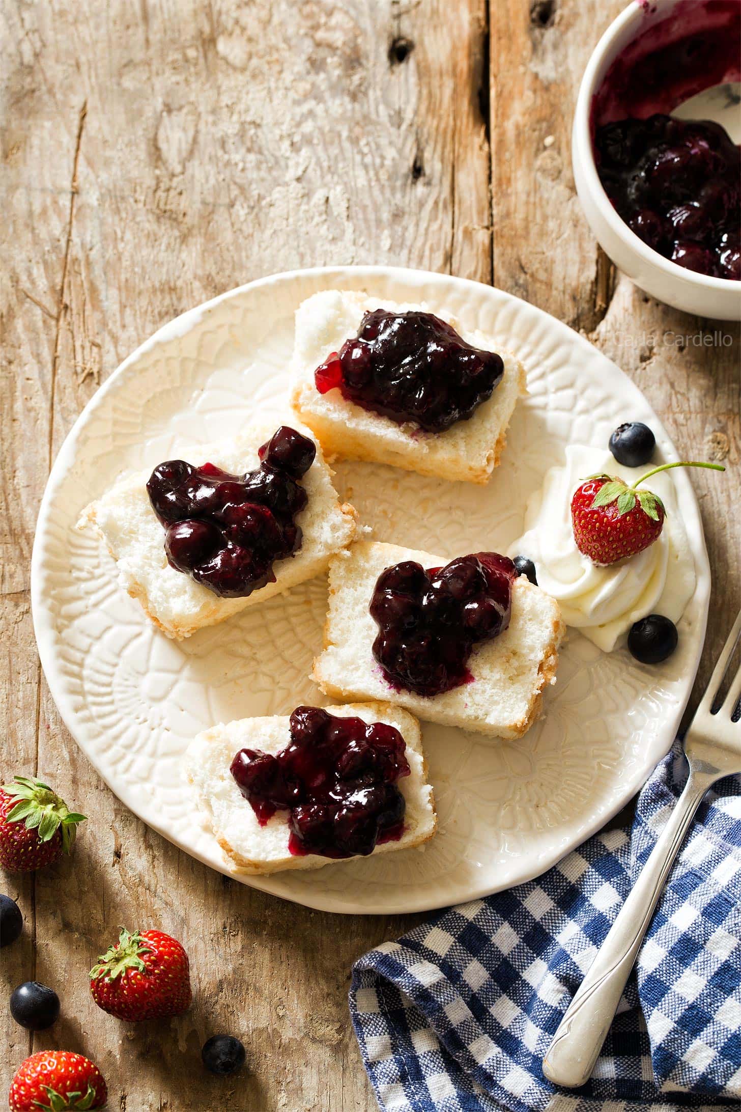 Slices of angel food cake with blueberry pie filling