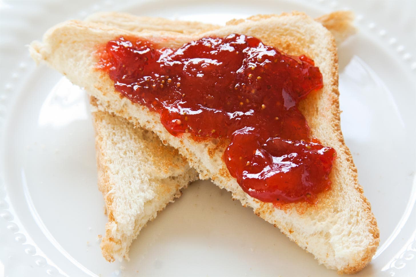 Close up of strawberry jam spread onto toast