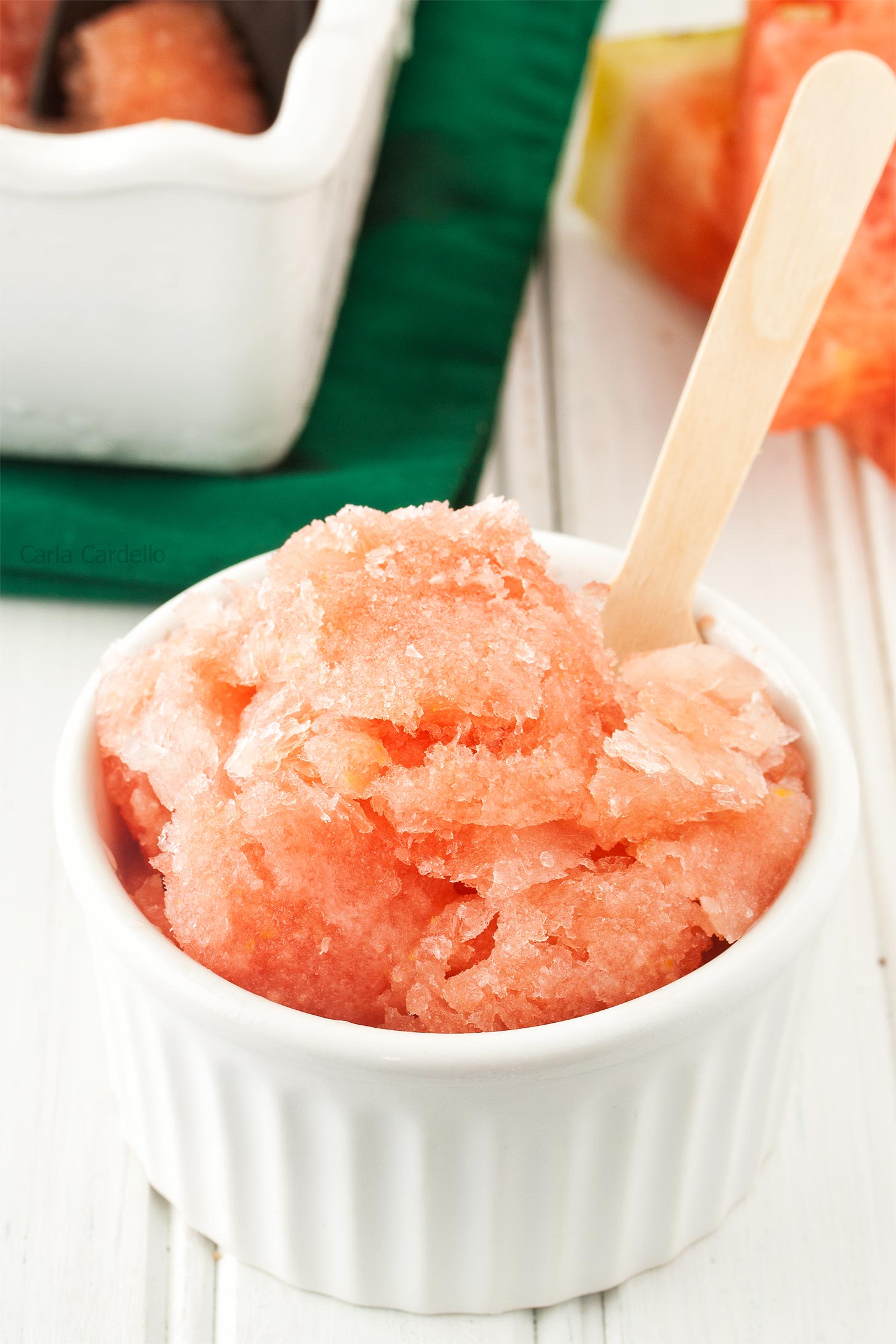 Watermelon Ice with wooden spoon in white ramekin