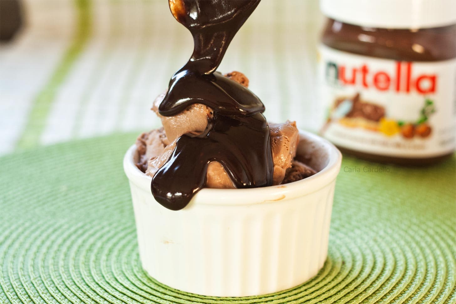 Nutella sauce being poured on top of Nutella ice cream