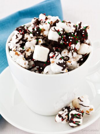 Chocolate covered popcorn in a coffee mug