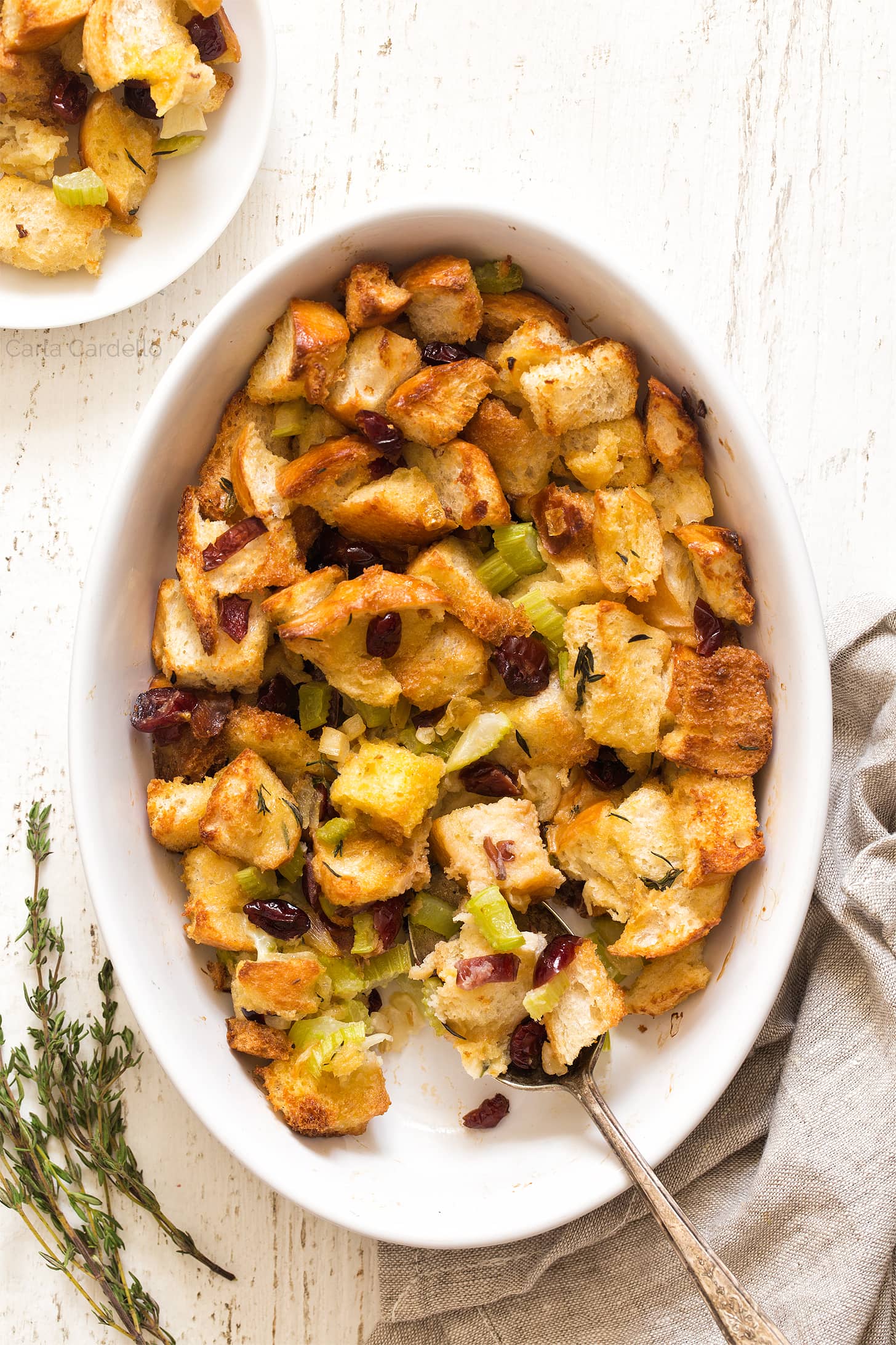 Cranberry Stuffing with serving spoon in casserole dish