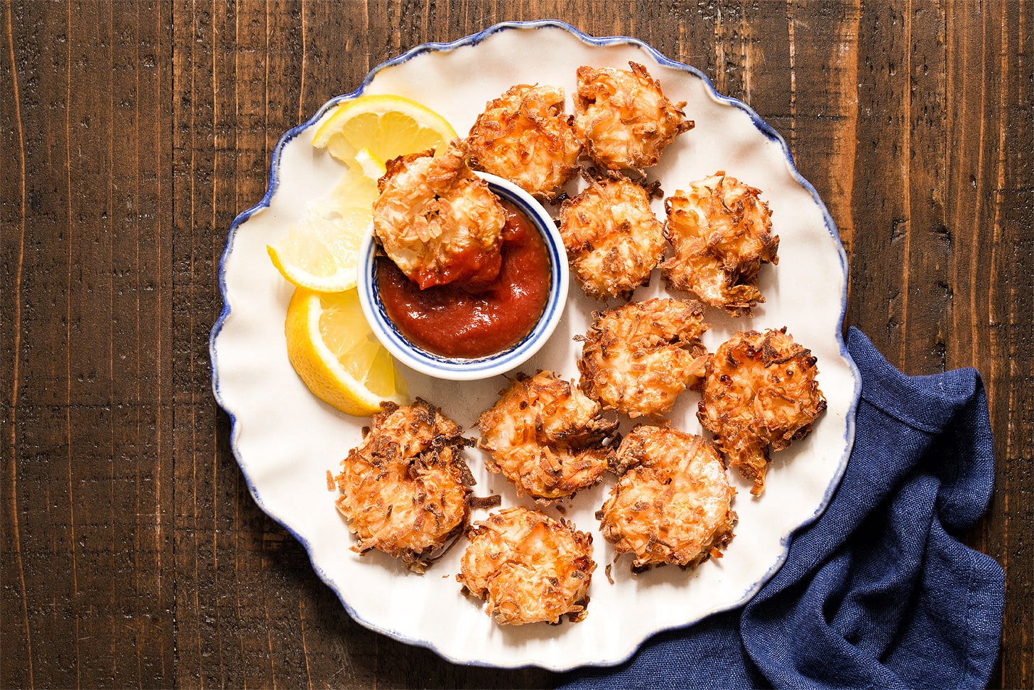 Air Fryer Coconut Shrimp on white plate with blue border