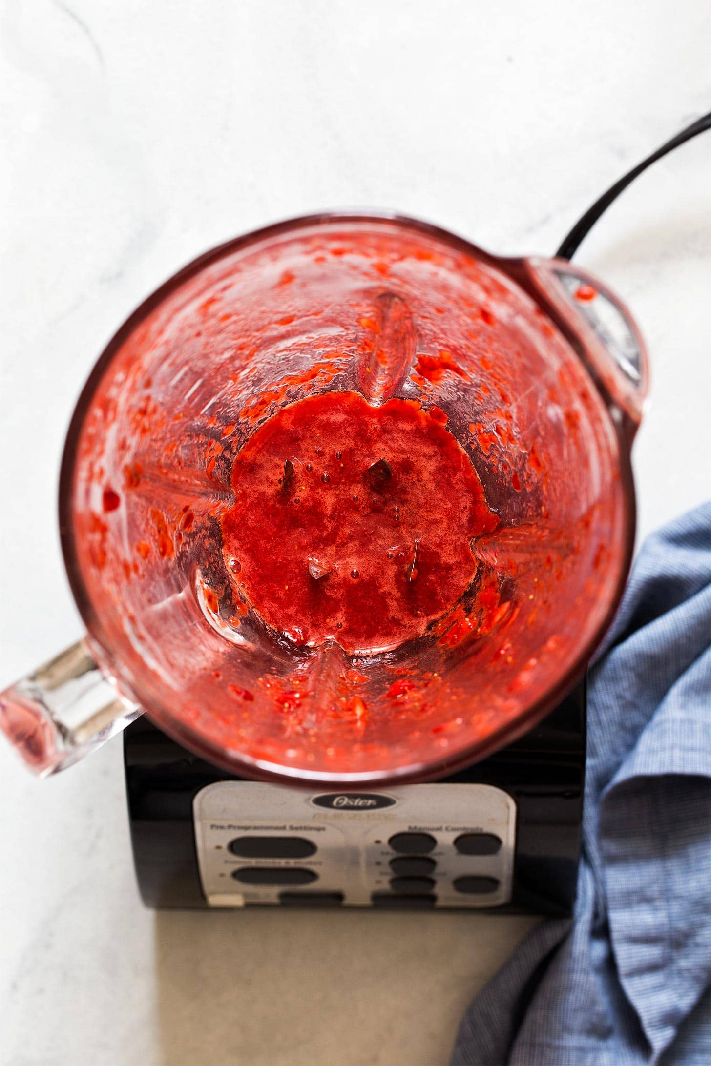 Blending strawberries for strawberry cream cheese frosting