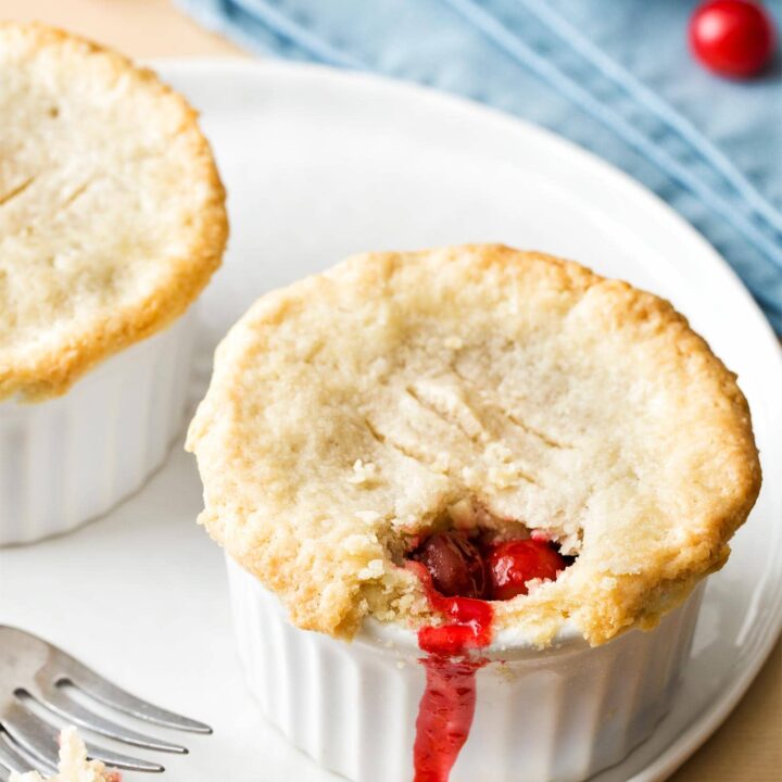 Close up of mini cherry pie on white plate
