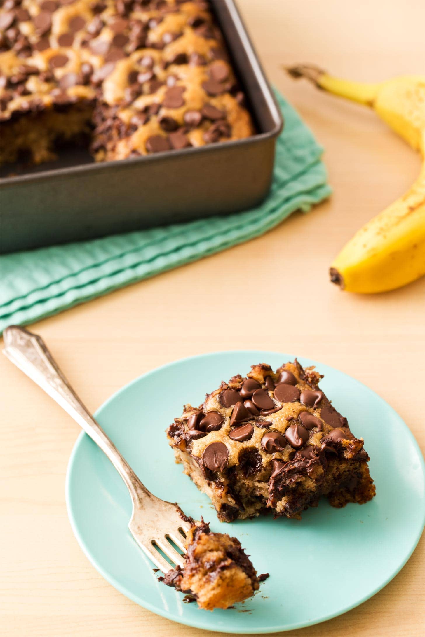 Slice of banana snack cake on blue plate