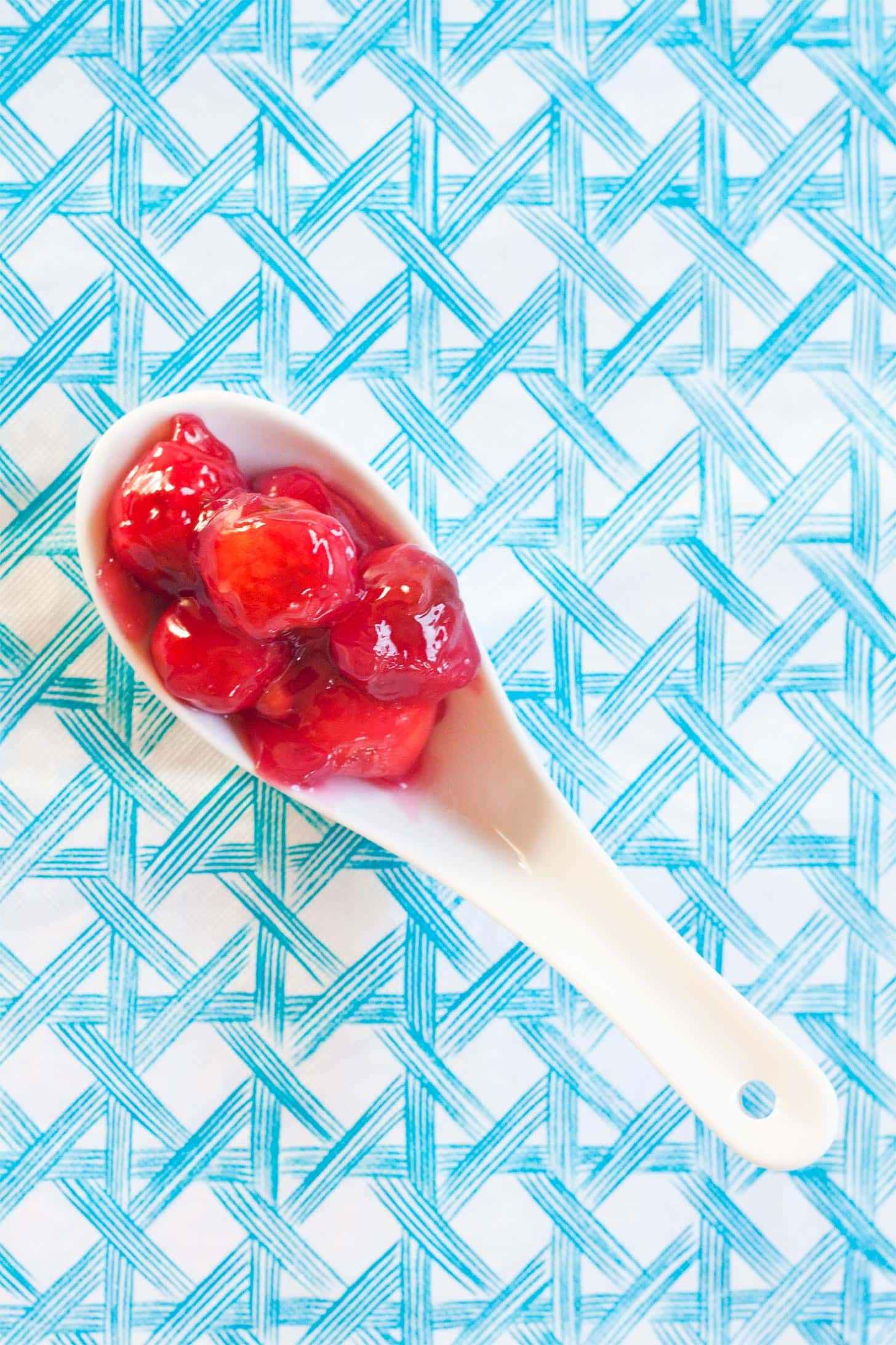 Sour cherry pie filling on a white spoon
