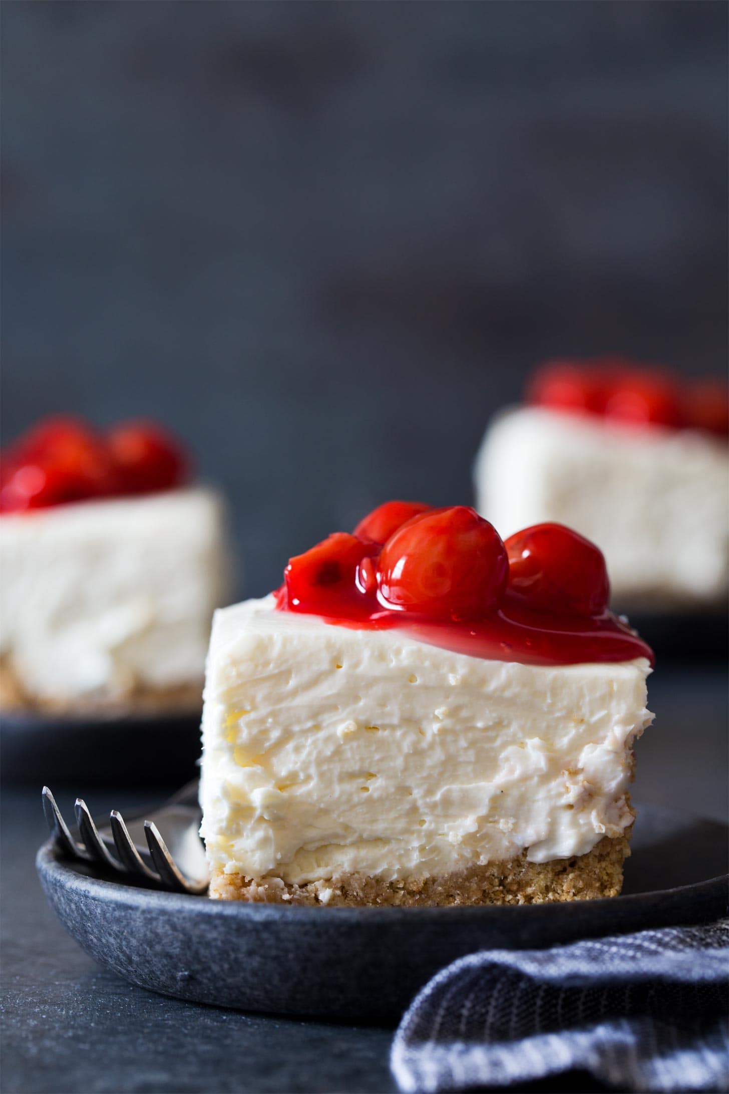 No Bake Cheesecake Bars with cherry pie filling on plates
