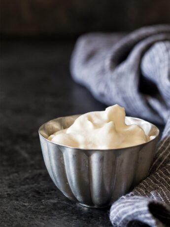 Homemade whipped cream in a silver bowl
