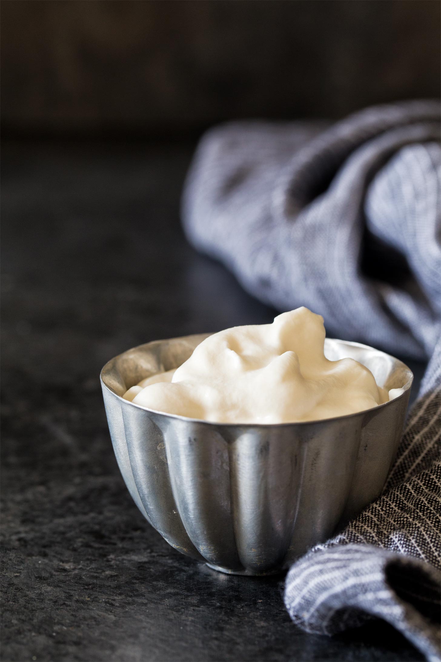 Homemade whipped cream in a silver bowl