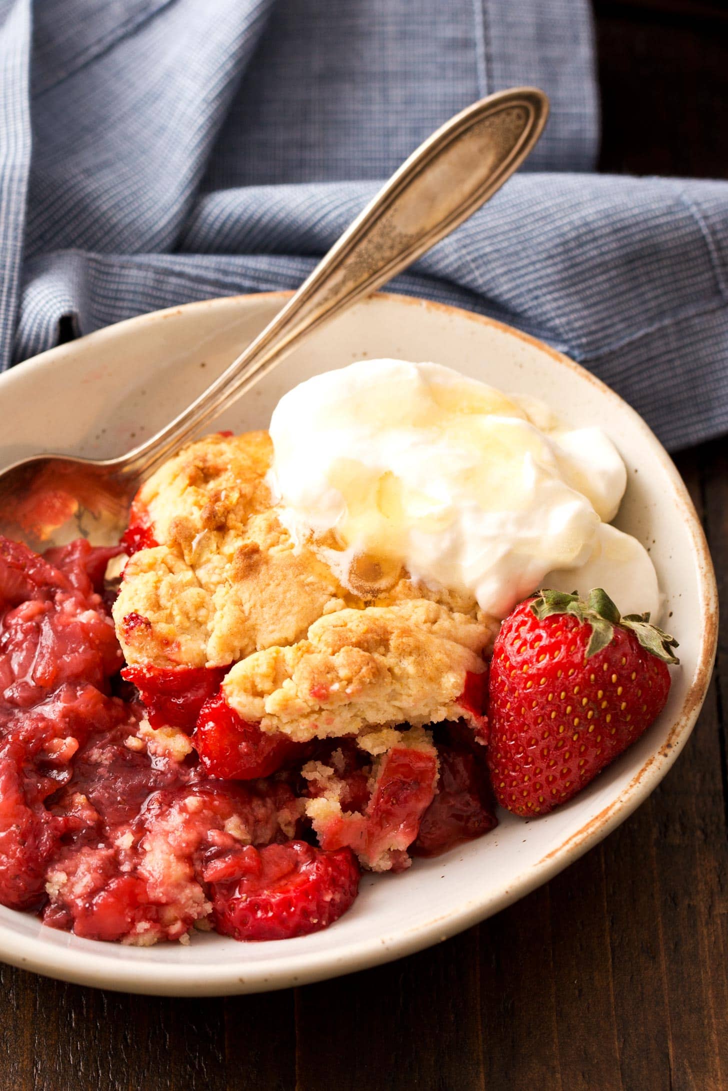 Honey whipped cream served on top of strawberry cobbler