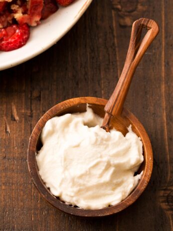 Honey whipped cream in small brown bowl