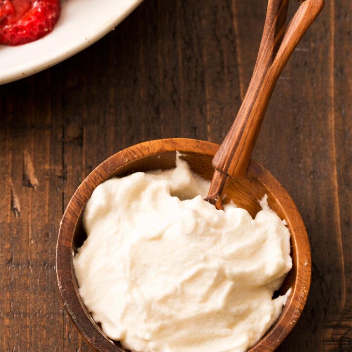 Honey whipped cream in small brown bowl