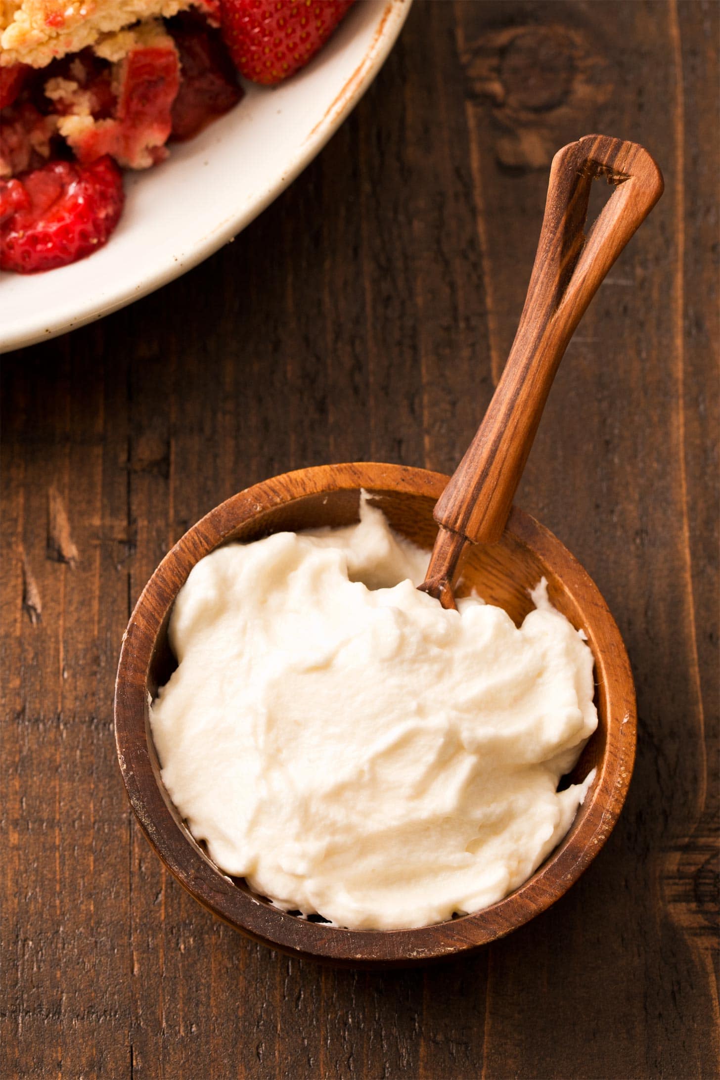 Honey whipped cream in small brown bowl