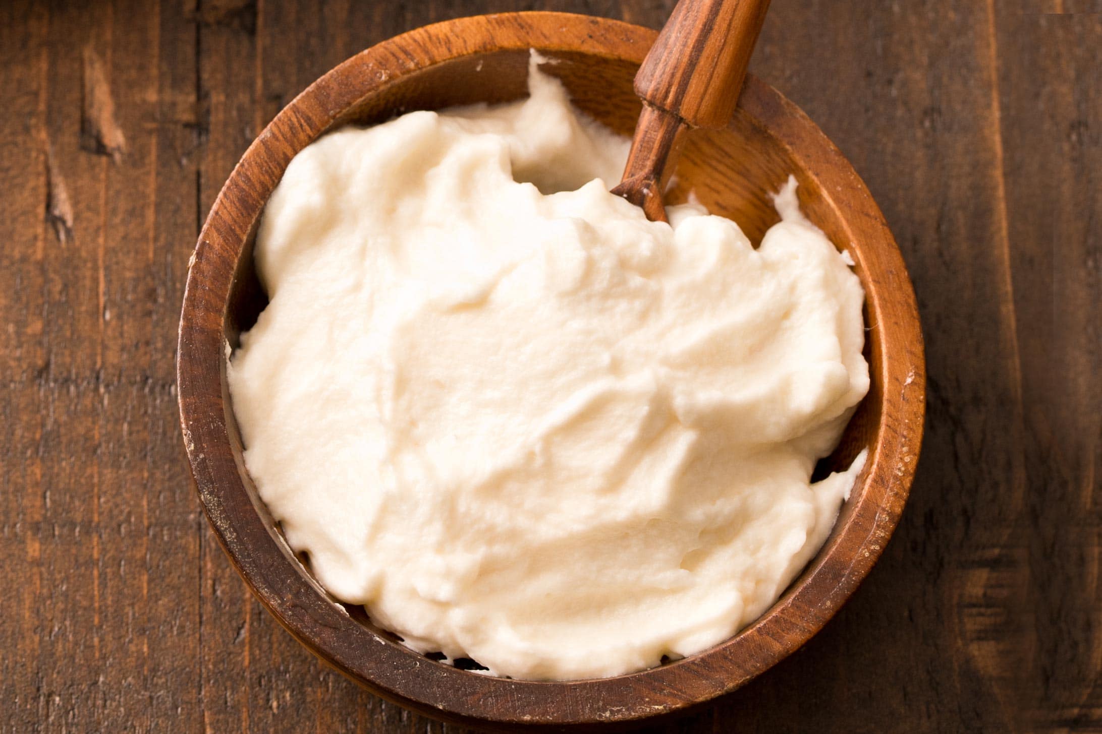Close up of whipped honey cream in brown bowl