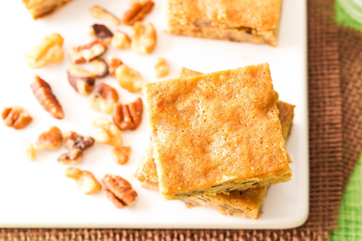 Banana bread blondies on cutting board with nuts